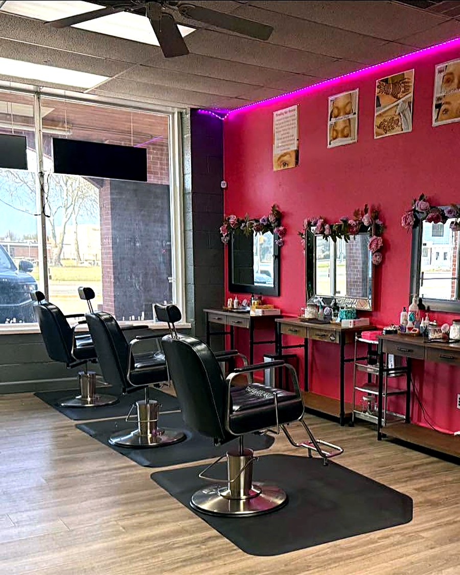 Inside Kinza's Brow Bar & Spa — burnt-orange accent wall, styling stations and mirrors